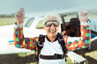 © Marko Geber - Excited senior woman cheering after successful skydiving adventure