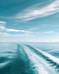 Poster - Serene ocean vista with boat wake under a bright blue sky and wispy clouds in the distance