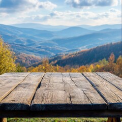 Poster - Rustic Wooden Tabletop Overlooking Scenic Autumn Mountain Landscape with Vibrant Foliage and Blue Sky Perfect for Product Display or Backgrounds