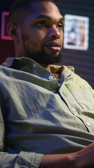 Poster - vertical video portrait of african american adult typing data on his laptop at home, being self empl