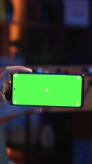 Poster - vertical video black freelancer uses green screen mockup on tablet to work in the living room, sitti