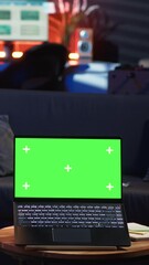 Poster - vertical video young male person enjoys leisure time next to chroma key on bean bag, uses his smartp