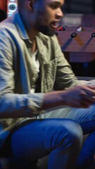 Poster - vertical video adult guy typing on laptop laying on couch in stylish apartment, engaging in freelanc