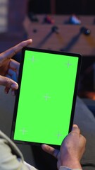 Poster - vertical video relaxed male tech user holding device with isolated mockup screen in his living room,