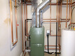 © lina - modern boiler system with copper pipes and green unit in mechanical room