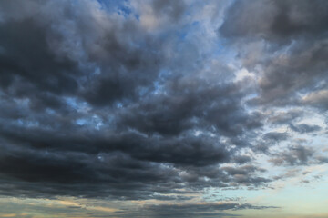 Wall Mural - Storm dark grey cumulus rain clouds against blue sky abstract background texture, thunderstorm