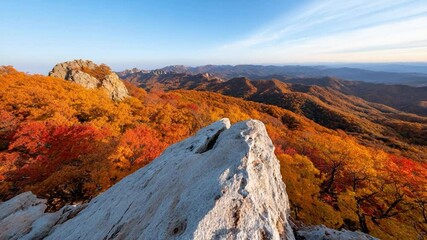Aufkleber - Stunning autumn mountain landscape featuring golden and red foliage with a prominent white rock formation under a clear blue sky