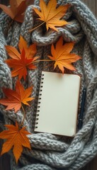 Poster - Autumnal Still Life with Notebook and Maple Leaves on Knitted Blanket for Cozy Fall Season
