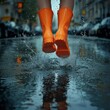 © Arwin - A person leaping through puddles in vibrant orange rain boots.