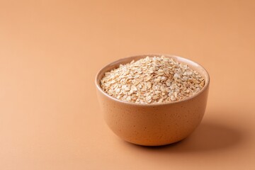 Poster - single bowl of oatmeal stands elegantly on smooth solid color background with ample copy space
