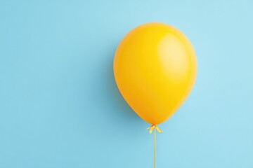 Poster - single yellow balloon with ribbon on smooth pastel blue background emphasizing minimalistic design