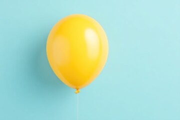Poster - single yellow balloon with ribbon on smooth pastel blue background emphasizing minimalistic design