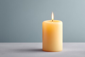 Poster - subdued table set with solitary lit candle against simple gray background