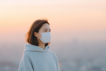 Poster - air pollution portrait individual wearing face mask against blurred cityscape minimalistic focus on contrast between