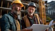 © Caspernik - Confident mature construction workers reviewing plans at building site
