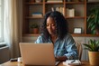 © Vera - African-American Group Freelancing from Home on Laptops: Embracing the Remote Work Lifestyle