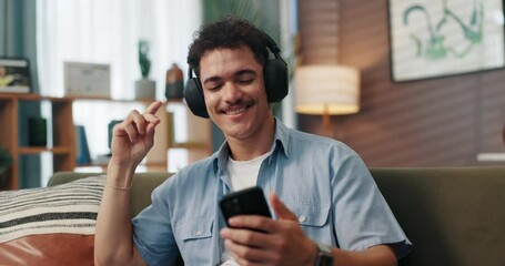 Aufkleber - Headphones, dance and man with cellphone on sofa in home for chatting, relaxing and listening to music. Audio tech, phone and person with networking and streaming album on mobile app in living room.