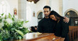 © DavidL2000/peopleimages.com - Couple, coffin and embrace at funeral for death, pay respect or comfort for loss in christian church. Sad man, woman and grief at memorial service with casket to mourn, hug or console for depression