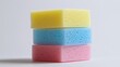 © aulaiphon - A stack of colorful cleaning sponges and scrubbers, isolated on a plain white background,