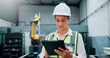© peopleimages.com - Woman, technician and tablet at robotics factory for research, machine update and technical guide. Female engineer, digital and production manual, automation safety and information for manufacturing