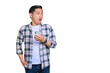 © Sewupari Studio - Shocked young Asian man in plaid shirt holding mobile phone and looking aside at copy space isolated on transparent background