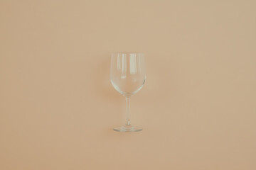 Aufkleber - Elegant Glassware: A delicate, empty glass catches the light, showcasing its sleek design against a soft, neutral backdrop. Simple beauty in every curve.