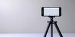 © regulator - Phone rests on a tripod