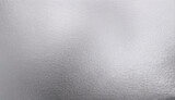 Close-up of a shiny silver foil texture with reflective properties and metallic sheen