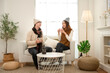 © tonefotografia - Cozy Indoor Moment Between a Couple Enjoying Warm Beverages in a Stylish Living Room