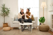© tonefotografia - Cozy Indoor Moment Between a Couple Enjoying Warm Beverages in a Stylish Living Room