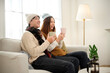 © tonefotografia - Cozy Indoor Moment Between a Couple Enjoying Warm Beverages in a Stylish Living Room