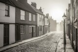 Misty, historical street lined with quaint, gray buildings.  Cobblestone path leads to a foggy, distant archway.  Street lamp casts a warm glow