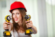 © Voyagerix - Woman using power driil for work at home