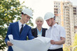 © A Stock Studio - Teamwork engineers builder discussing the project of a new house under construction. Group of construction specialists.