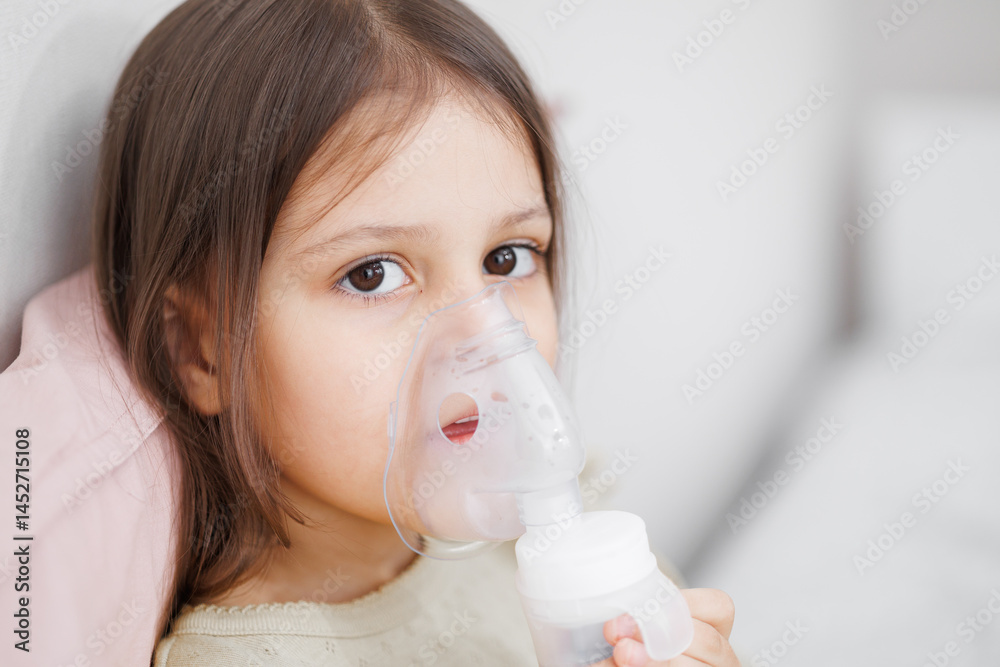 child is sick in bed. inhalation at home. Mom gives medicine to her ...