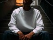 © ulum - Blank sweatshirt mockup on male model seated on stairs, relaxed and moody vibe