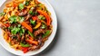 © Hox - Pasta with peppers, cilantro, and sliced beef. A colorful stir-fry with noodles