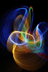 Poster - abstract light painting with vibrant colors creating dynamic swirling patterns on a dark background 