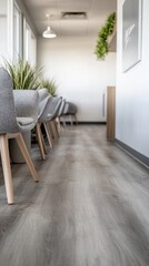 Poster - Serene waiting area featuring comfortable gray chairs and vibrant green plants creating a calming and inviting atmosphere with modern design and bright light