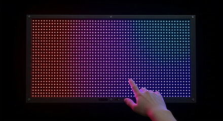 Fototapete - Hand touching interactive led panel displaying gradient colors in dark room