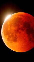 Wall Mural - dramatic close up of a blood moon eclipse with sunlight creating a warm glow in the dark space showi