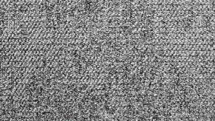 Fototapete - A gray and white carpet with a lot of small rocks on it. The carpet is very textured and has a lot of different colors.
