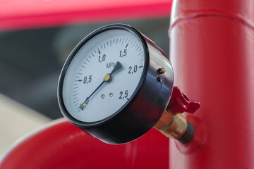 Aufkleber - Red pipe with white pressure gauge on it. Industrial concept background.
