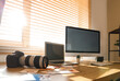 © Pixel-Shot - Photographer's workplace with blank computer and laptop near window in office