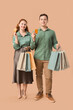 © Pixel-Shot - Beautiful young couple with shopping bags and credit cards on brown background