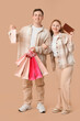 © Pixel-Shot - Beautiful young couple with shopping bags and wallet on brown background