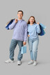 © Pixel-Shot - Beautiful young couple with shopping bags on grey background
