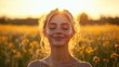© paukan - Serene blond woman immersed in golden sunlit field of yellow wildflowers