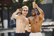 © prostooleh - Two male friends in a swimwears relaxing with a cocktails near swimming pool