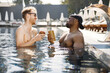 © prostooleh - Two male friends relaxing with a cocktails in a swimming pool